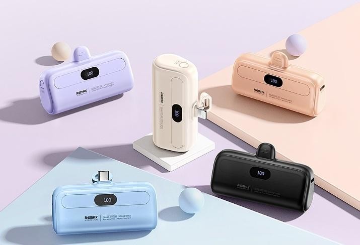 Collection of colorful mini capsule Portable Power Bank chargers with built-in plugs.