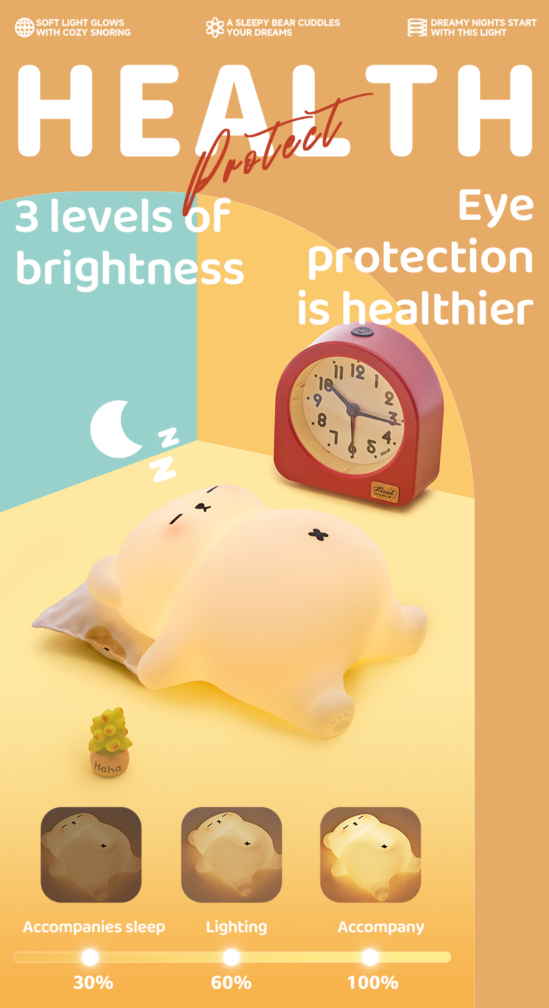 Glowing bear-shaped night light lying on a pillow next to a red desk clock, with three small inset photos showing 30%, 60%, and 100% brightness modes.